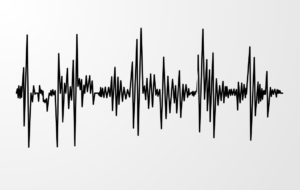 Illustration showing a black waveform on a white background, representing sound waves.