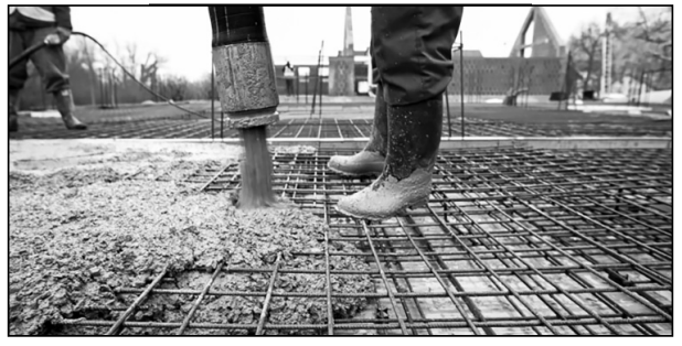 null Construction workers pouring concrete over a steel frame at a construction site, possibly preparing a foundation.