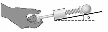 null Hand pulling back a spring launcher on an inclined track with a ball in front of the spring