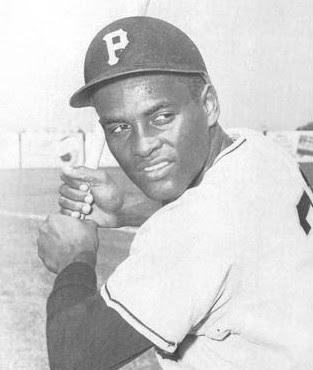 null Roberto Clemente holding a baseball bat.