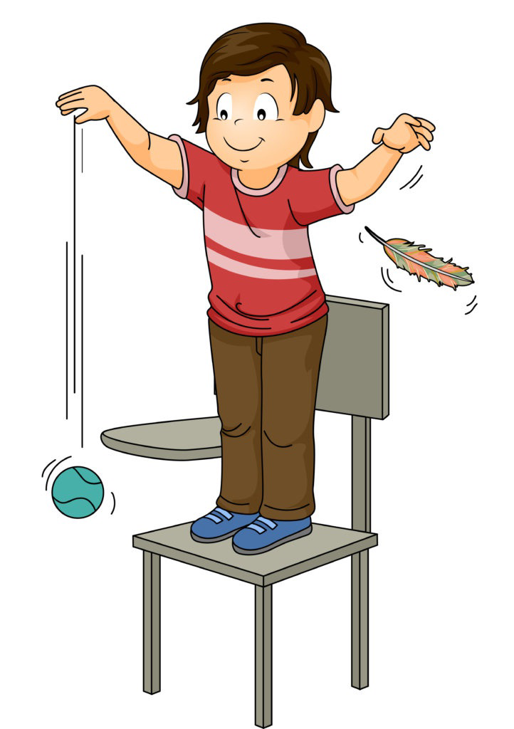 Child standing on a chair dropping a ball and a feather