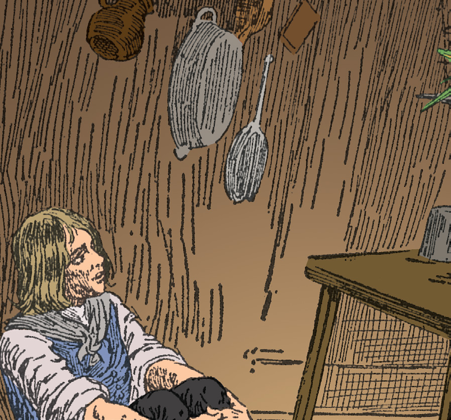 A boy sitting on the floor of a wooden room with pots and pans hanging on the wall.